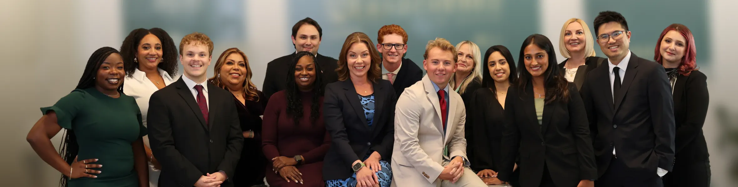 A large group of people in business attire posing together